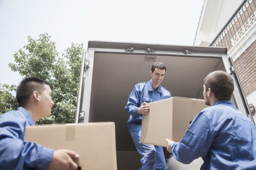 Removal van and moving team working in a Glasgow street