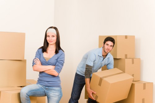 Team member carrying furniture carefully through a property