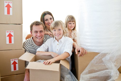 Packed boxes and furniture ready for collection in a Glasgow flat